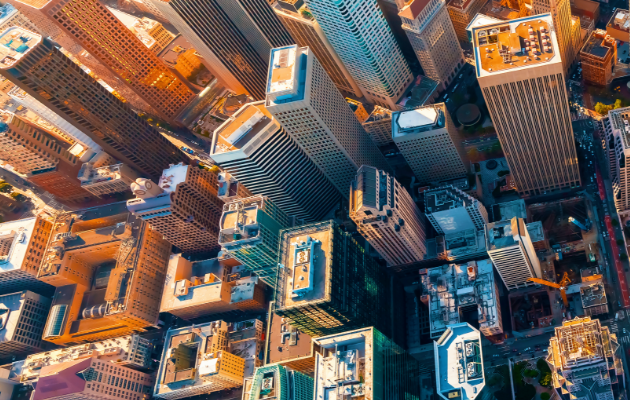 Bird's eye view of a city with sky scrapers at dusk